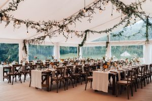 rustic trestle tables. greenery marquee