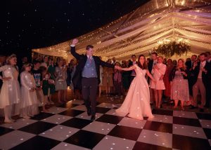 marquee black and white dancefloor. Bride and groom first dance
